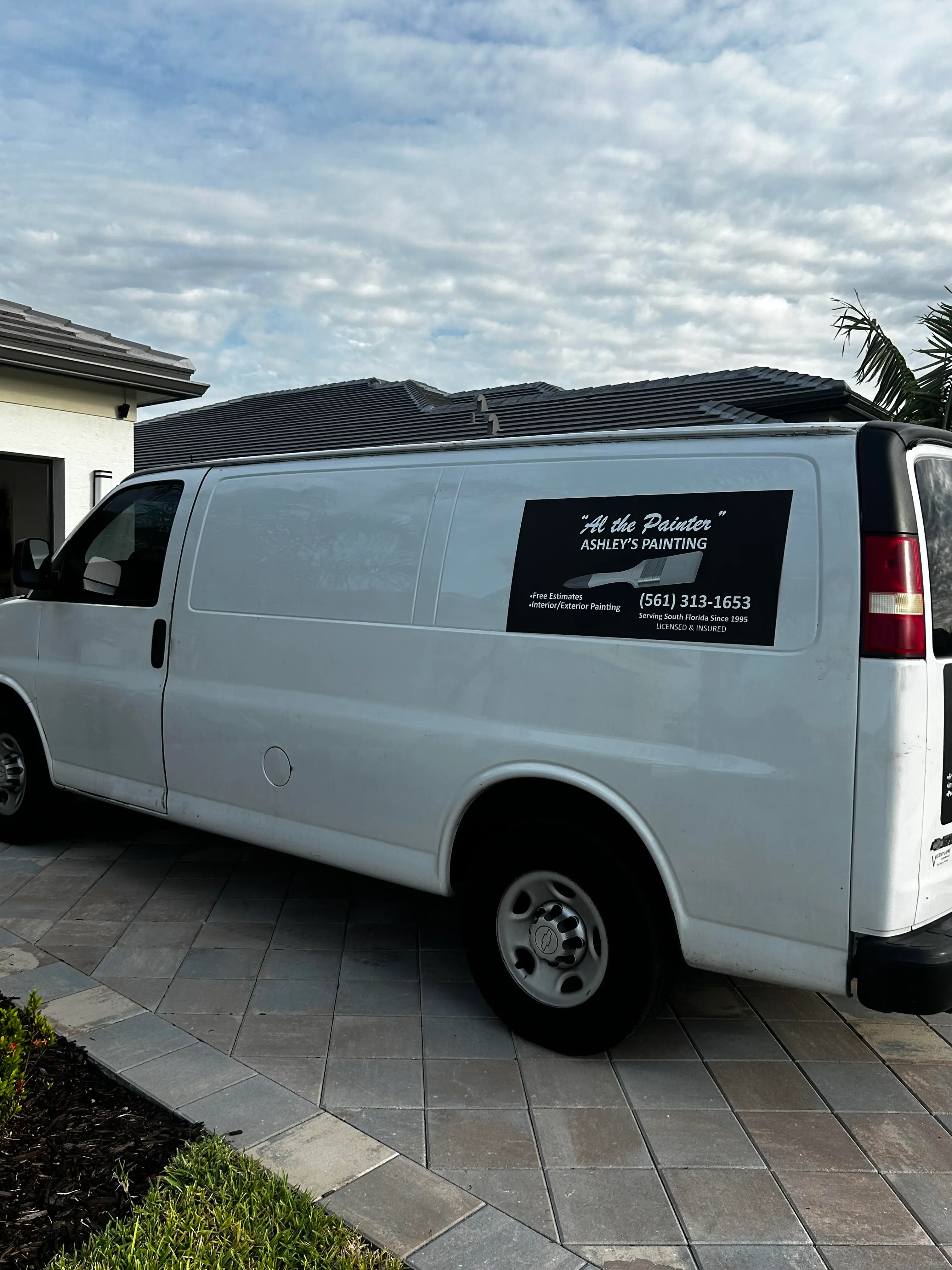 Ashley's Painting company work van parked outside a client home